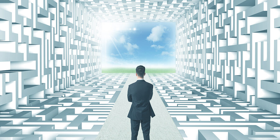 Successful businessman in front of a complicated labyrinth