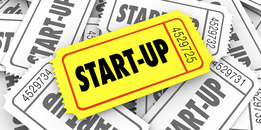 Start-Up word on a golden ticket in a pile of many competitors launching new companies or businesses and only one can be most successful