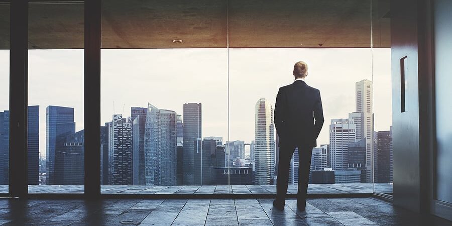 bigstock-Businessman-looking-at-city-59349905
