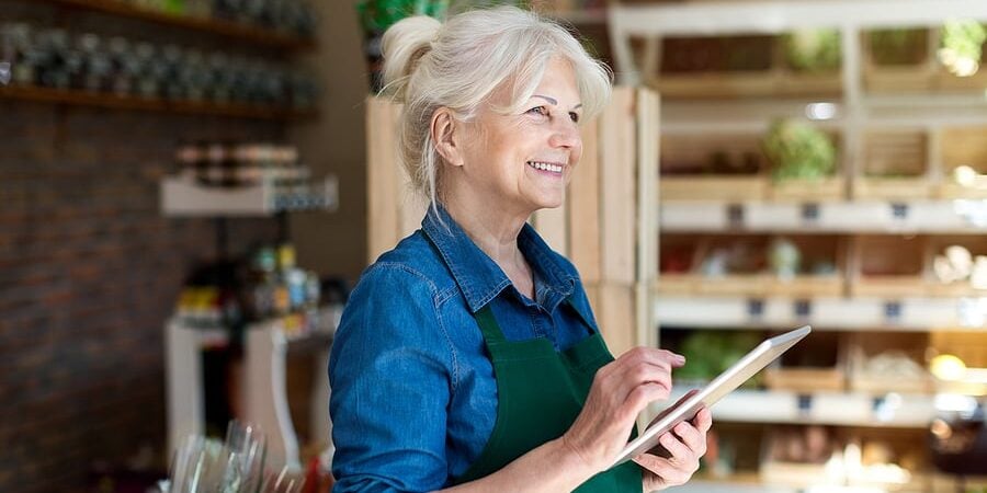 bigstock-Shop-assistant-with-digital-ta-295530130